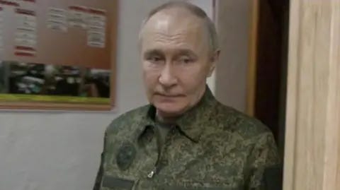 Kremlin.ru Vladimir Putin wearing a military uniform looks pensive in a blurred photo apparently near the front in Kursk