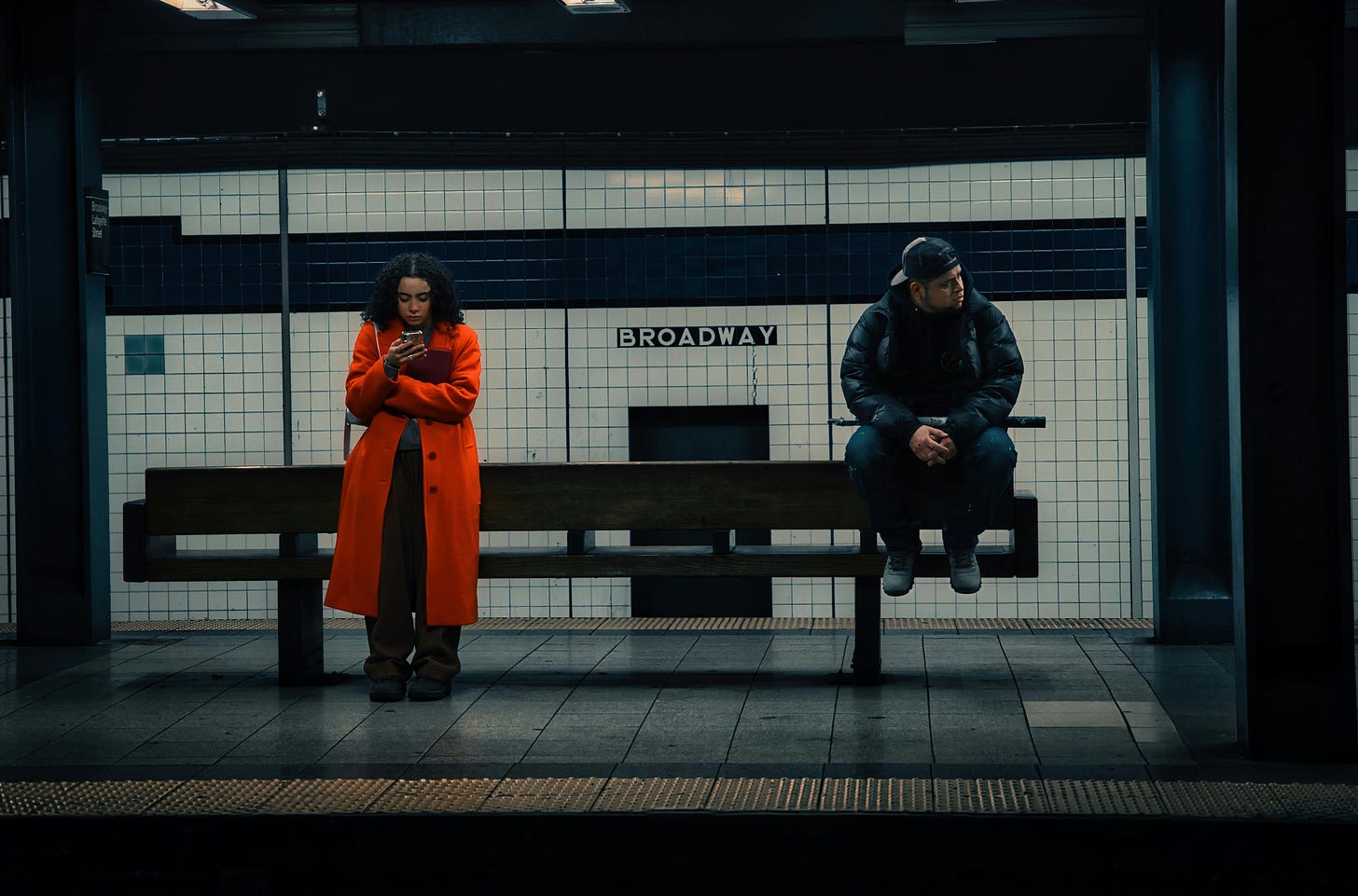 Man and woman at a distance from one another in subway station