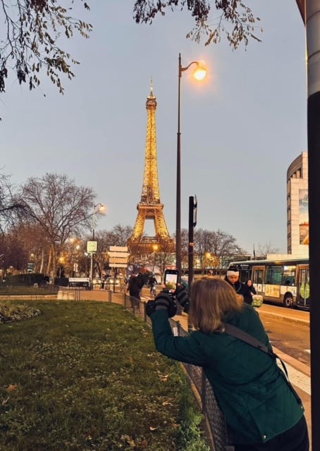 Jessica taking a picture of the Eiffel Tower