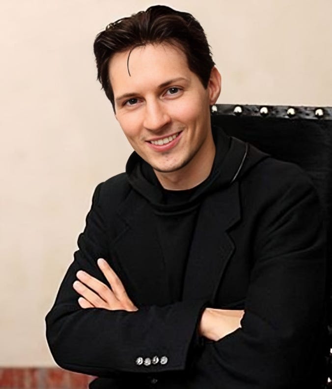 Pavel Durov, the CEO of Telegram, sitting with arms crossed and smiling, amidst recent reports of his politically charged detention, highlighting concerns over Big Tech censorship and free speech.