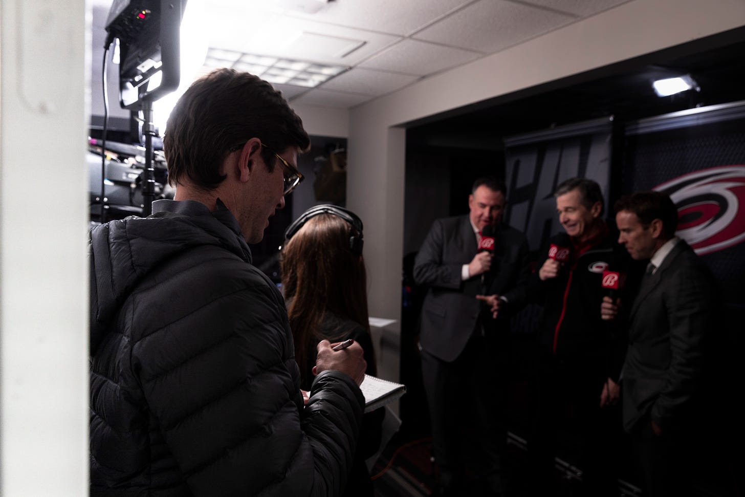 Jeremy reporting on Gov. Roy Cooper's visit to a Carolina Hurricanes game