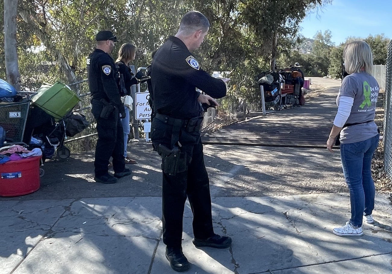 Escondido police monitor the clearing of a homeless encampment along with Escondido Creek near Harmony Grove on Monday. Steve Puterski photo