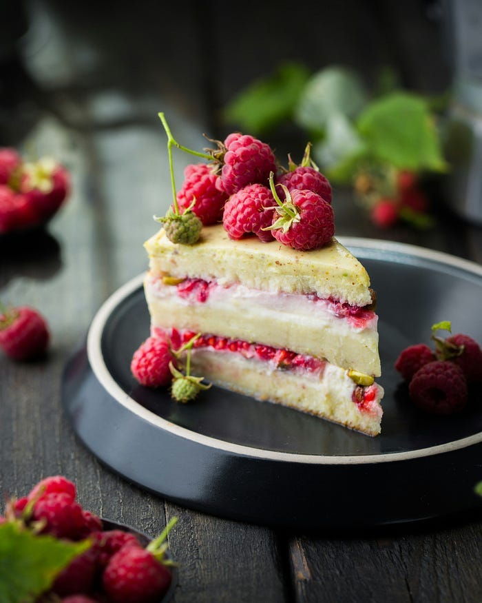 A small slice of berry cake on a ceramic plate. A small slice of berry cake on a ceramic plate.
