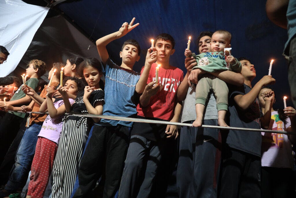 Palestinian children hold a candlelight vigil at Al-Shifa' Hospital in Gaza City, November 03, 2023.