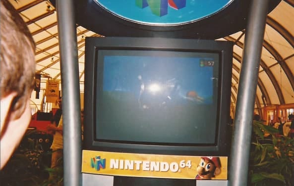 Another photo of an attendee playing Pokémon Snap on a Nintendo 64