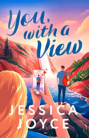 Book Cover of Jessica Joyce's You, With a View. A blonde white woman takes a photo for social media of a young white man standing by a desert lake and staring off into the distance.