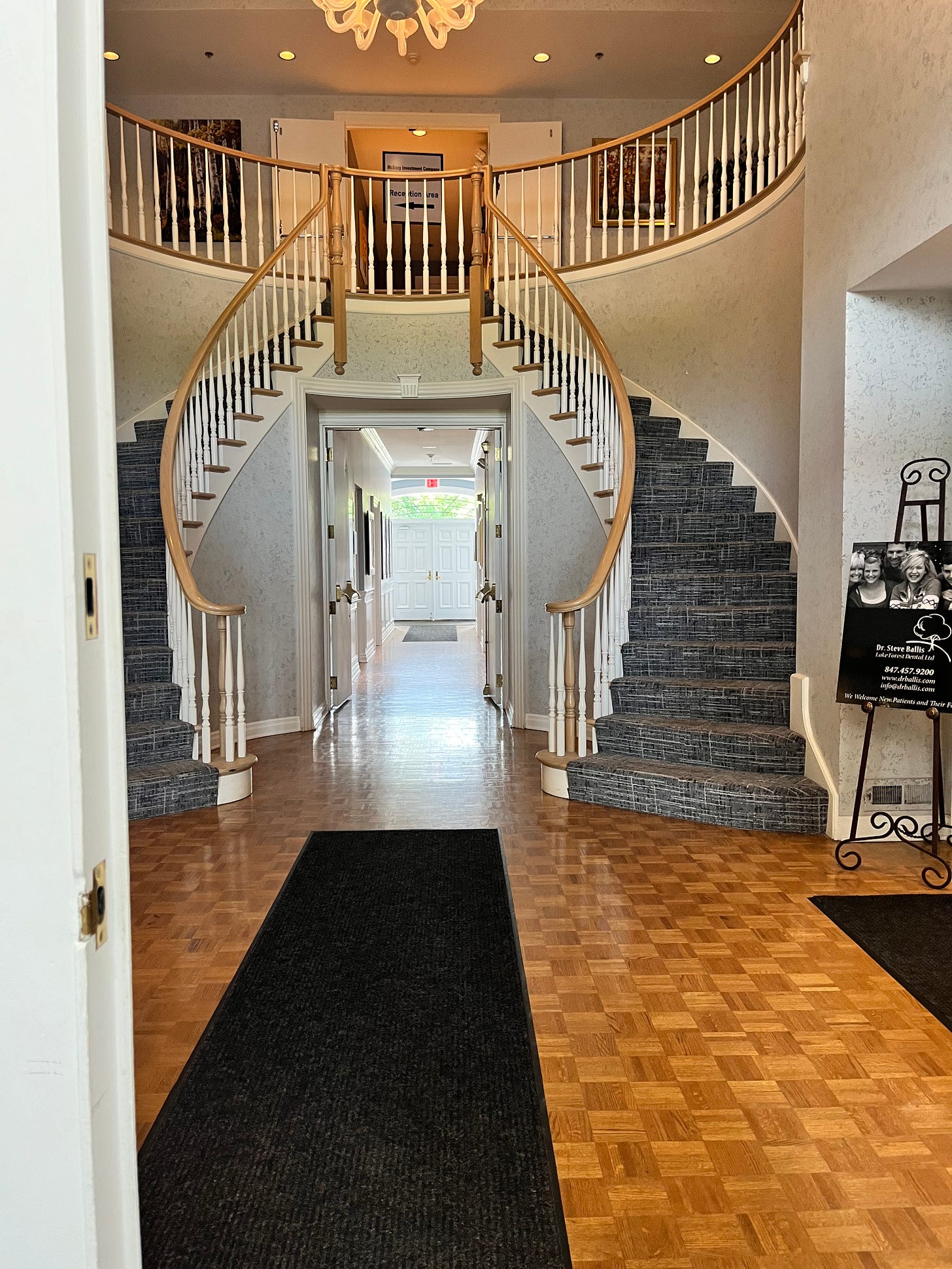 A double spiral staircase with open doors at the top and bottom.