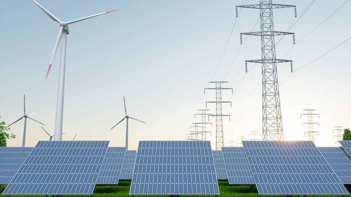 Clean energy wind turbines and solar panels with a high-voltage transmission line.