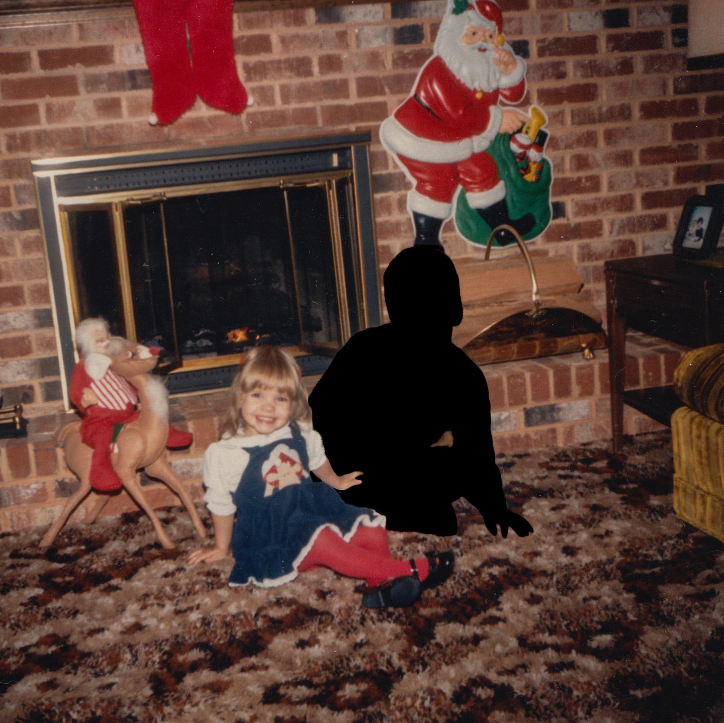 My brother and I in front of the fireplace during the holidays. I'm a toddler and he is silhouetted in black.