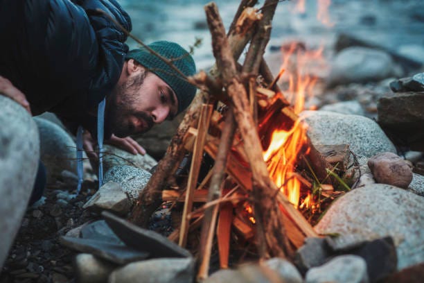 Young Man Burning The Campfire Mountainous Landscape Stock Photo - Download  Image Now - iStock