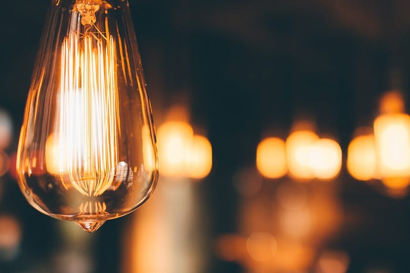 antique lightbulb with blurry lights in the back ground