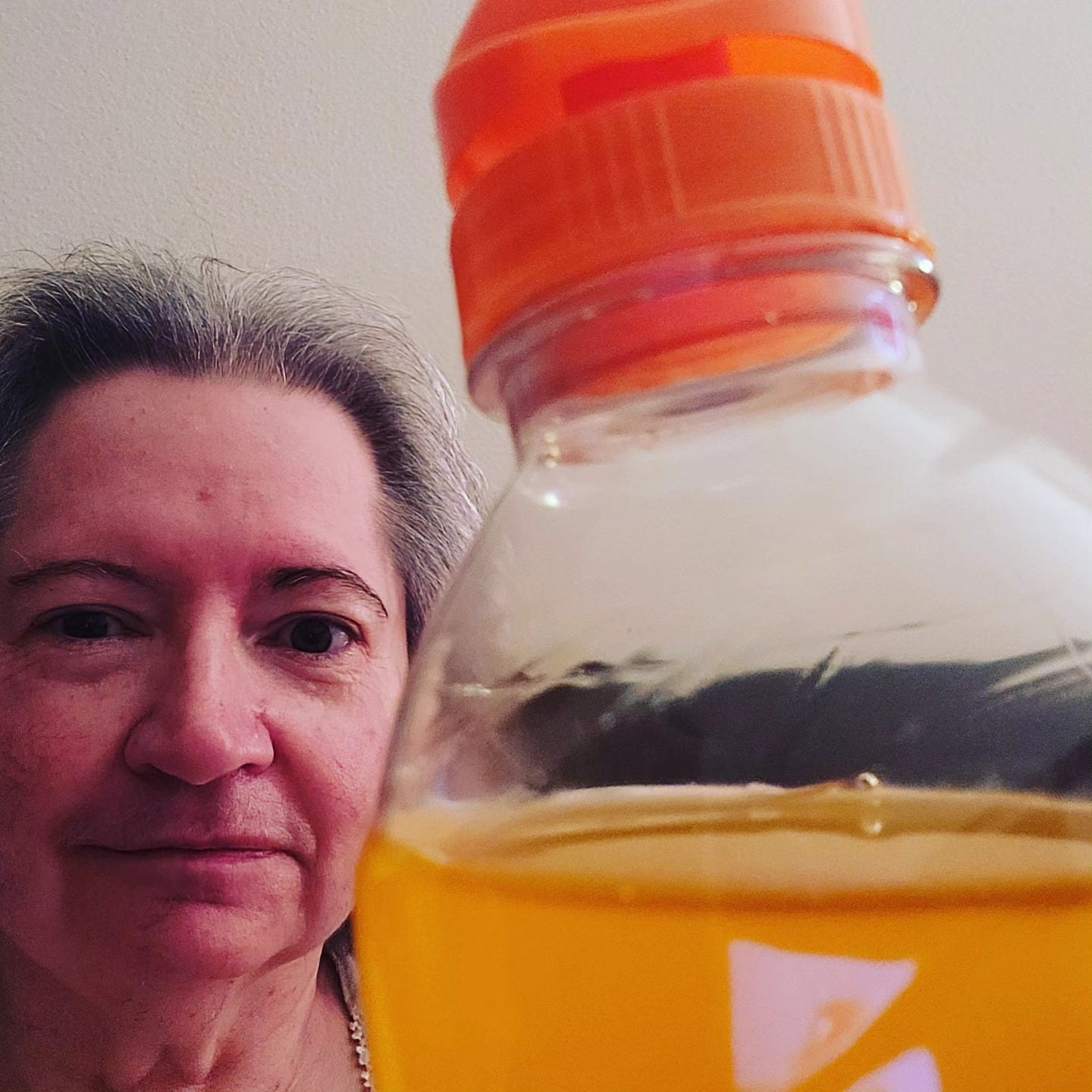 woman with a large bottle of orange Gatorade