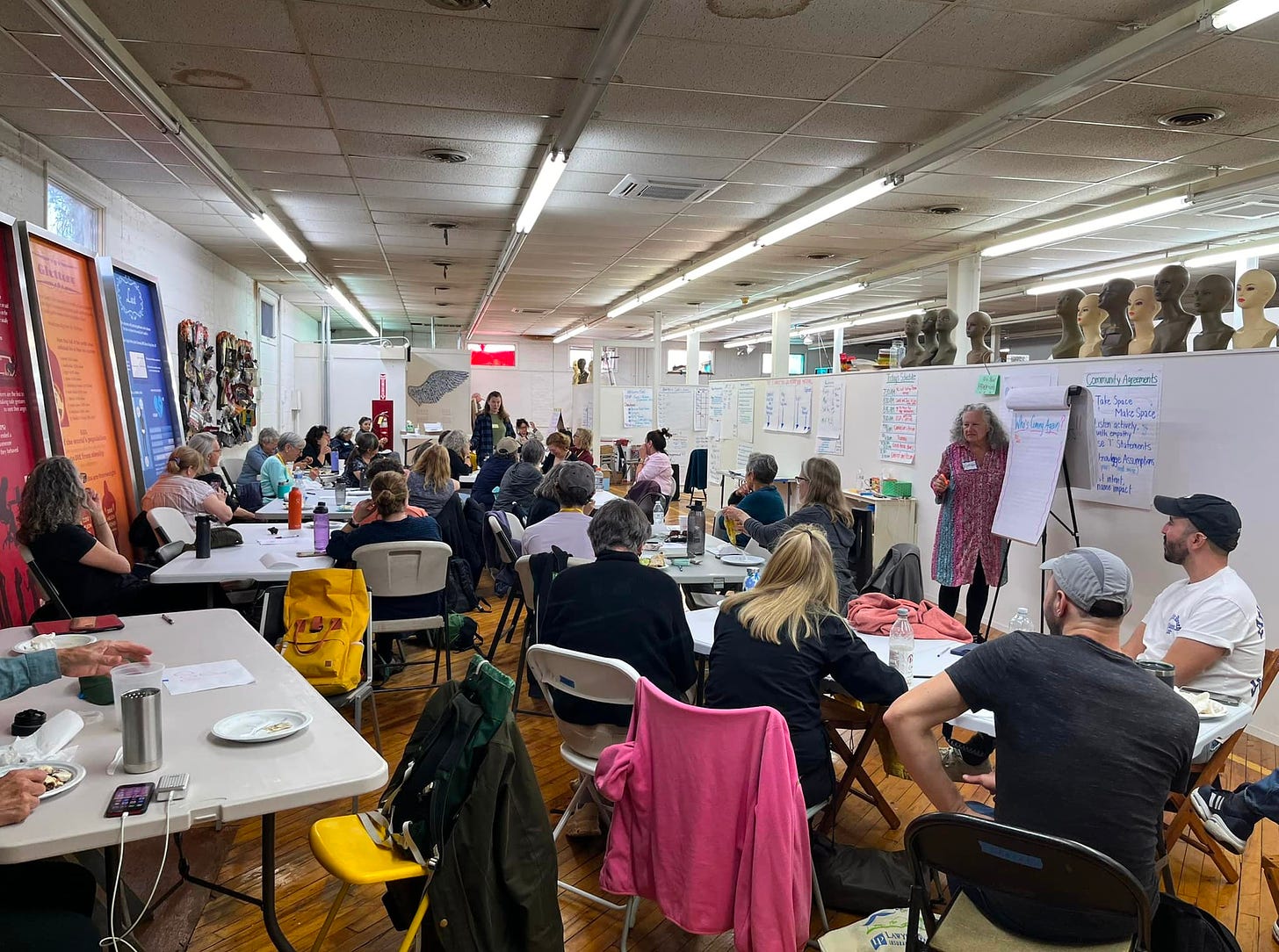 May be an image of 9 people, people studying, crowd and text