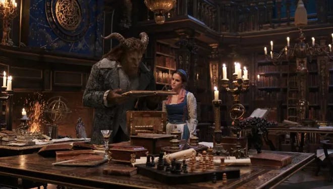 Beast and Belle in his library from the 2017 live action Beauty and the Beast.