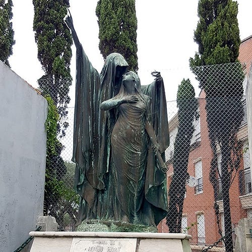 A graveyard monument depicting a cloaked figure, representing Death, embracing a woman holding a downturned torch.