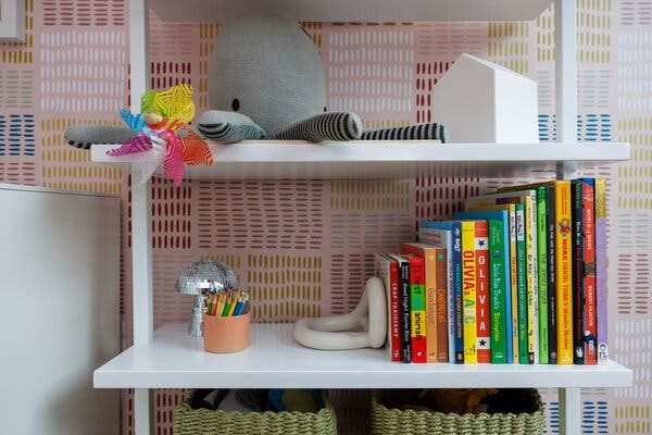 A close-up of shelves holding books and stuffed animals.