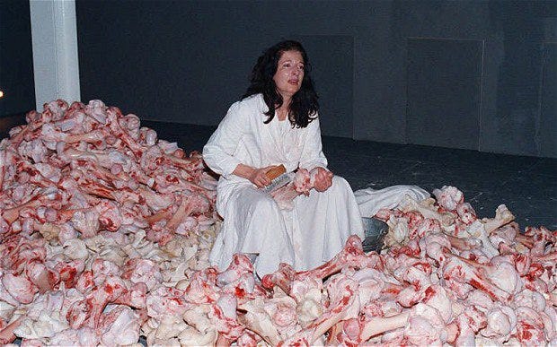 Marina abramovic on piles of meat.jpg