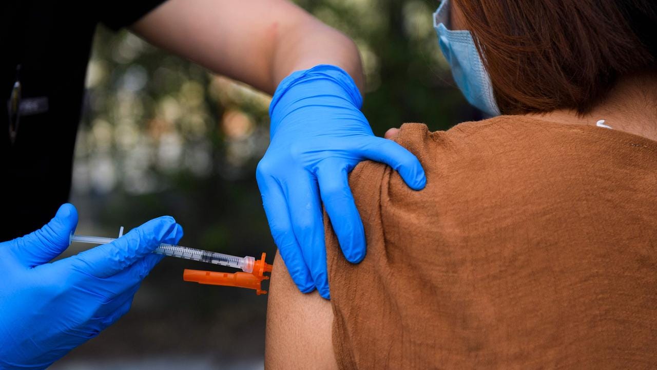 A 15-year-old receives a first dose of the Pfizer Covid-19 vaccine at a mobile vaccination clinic at the Weingart East Los Angeles YMCA in 2021. Picture: AFP
