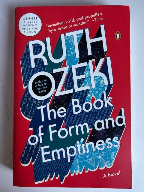 A book cover with a red background and blue and white lettering that reads Ruth Ozeki The Book of Form and Emptiness