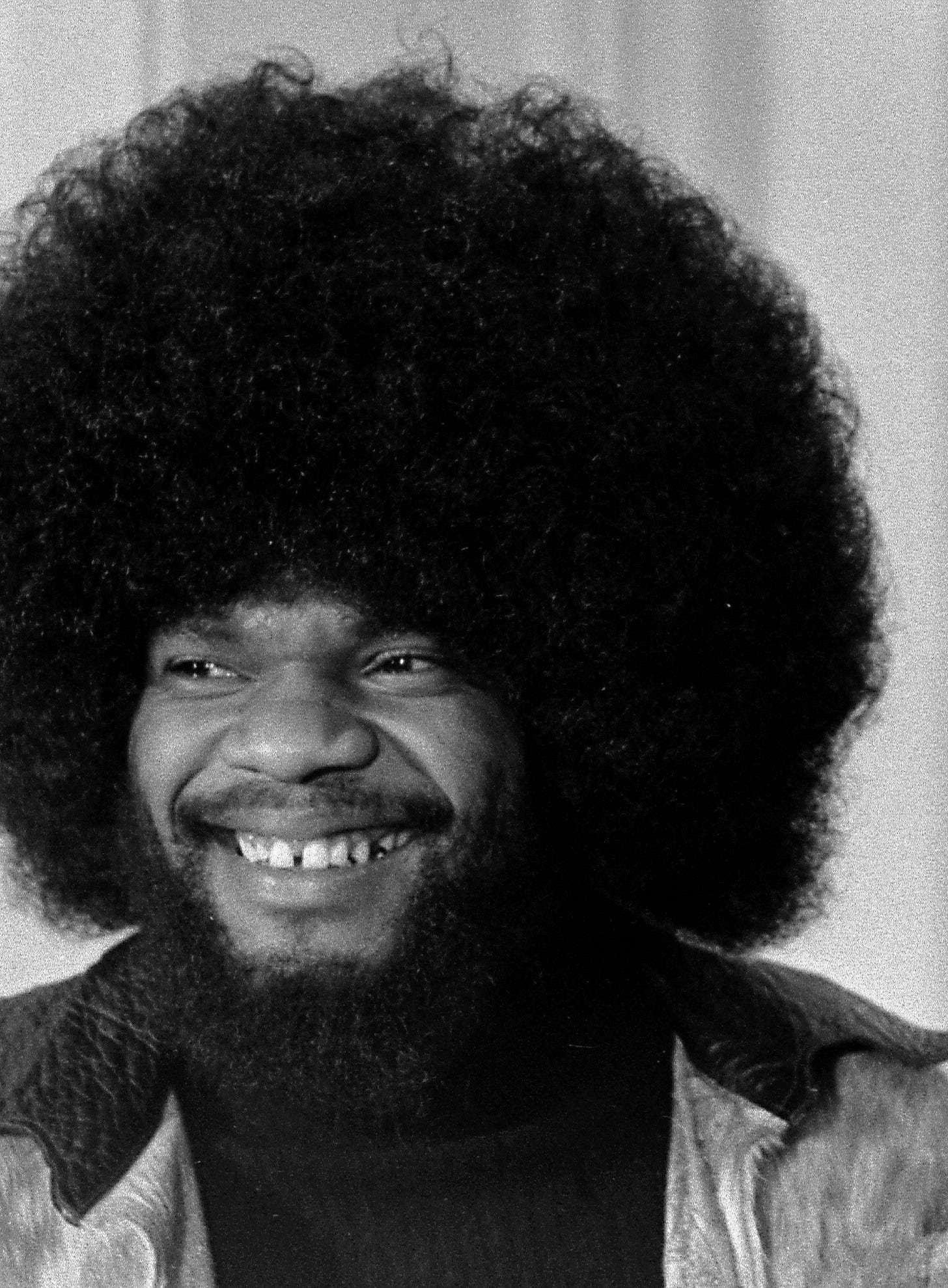 A photo of Billy Preston with a big afro, smiling.