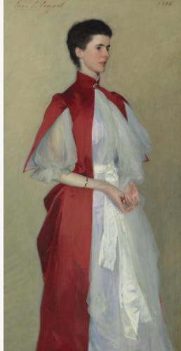 Mrs Robert Harrison (1886). In a soft diaphanous sift of a layered white dress with a wide cream sash, topped by a modern red silk cape — the juxtaposition of stiff structural cape and soft under dress is startling — and beautiful.