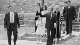 In this June 9, 1977 file photo, President Jimmy Carter waves as he departs the First Baptist Church in Washington with daughter Amy and daughter-in-law Caron Carter. 