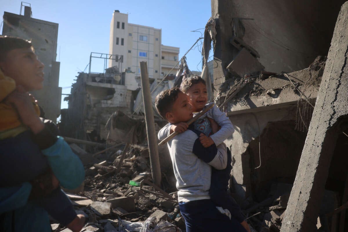 Palestinian children react as they inspect the rubble and debris at the site of Israeli strikes the night before at the Nuseirat refugee camp in the central Gaza Strip on March 23, 2025.