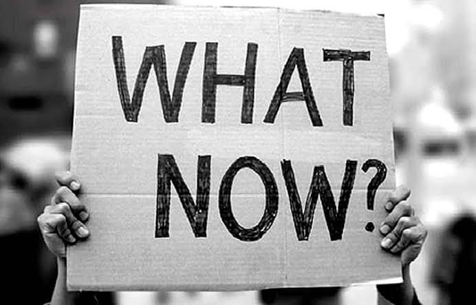 May be a black-and-white image of 1 person and text that says "WHAT NOW?"