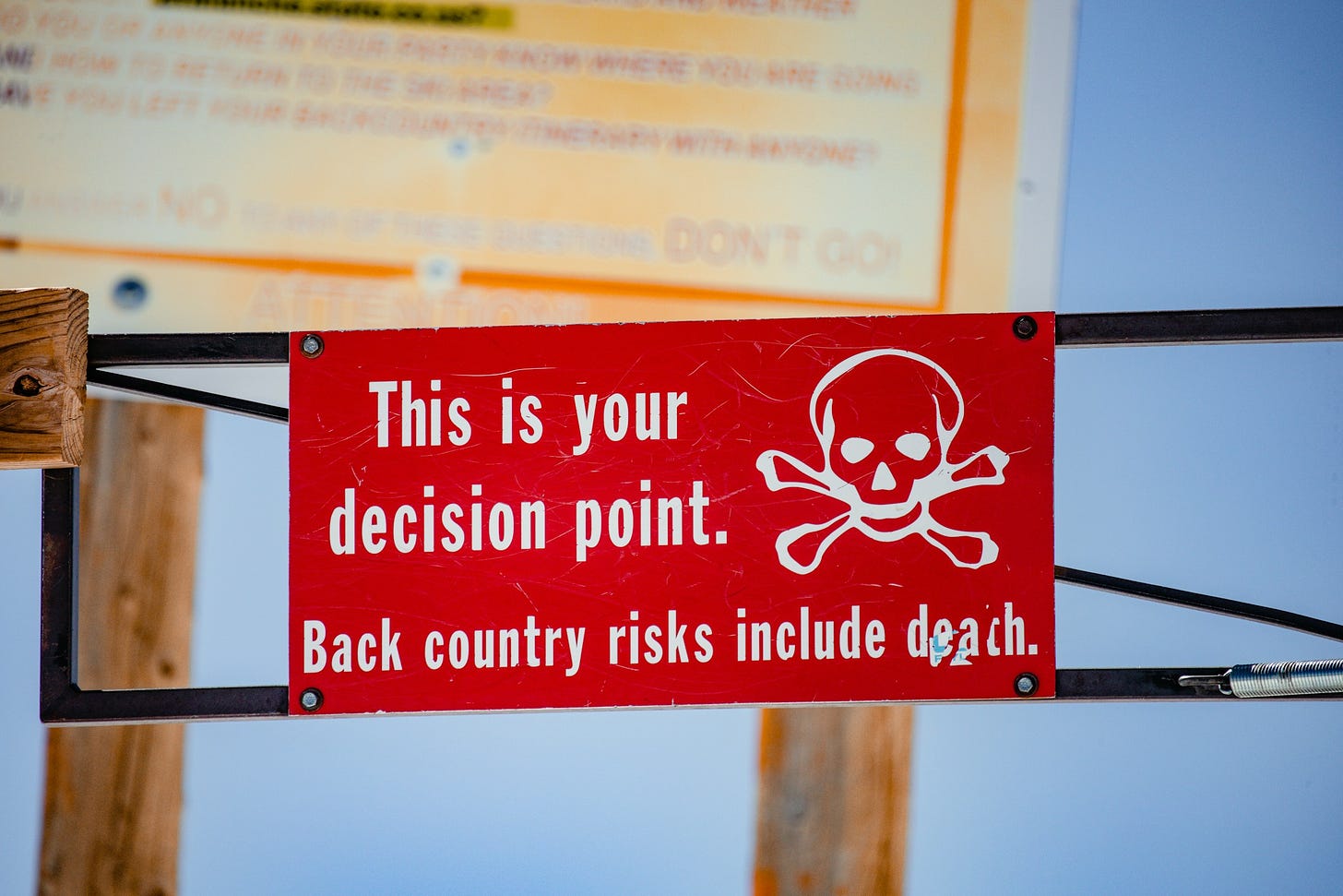 Sign reading "This is your decision point. Backcountry risks include death.