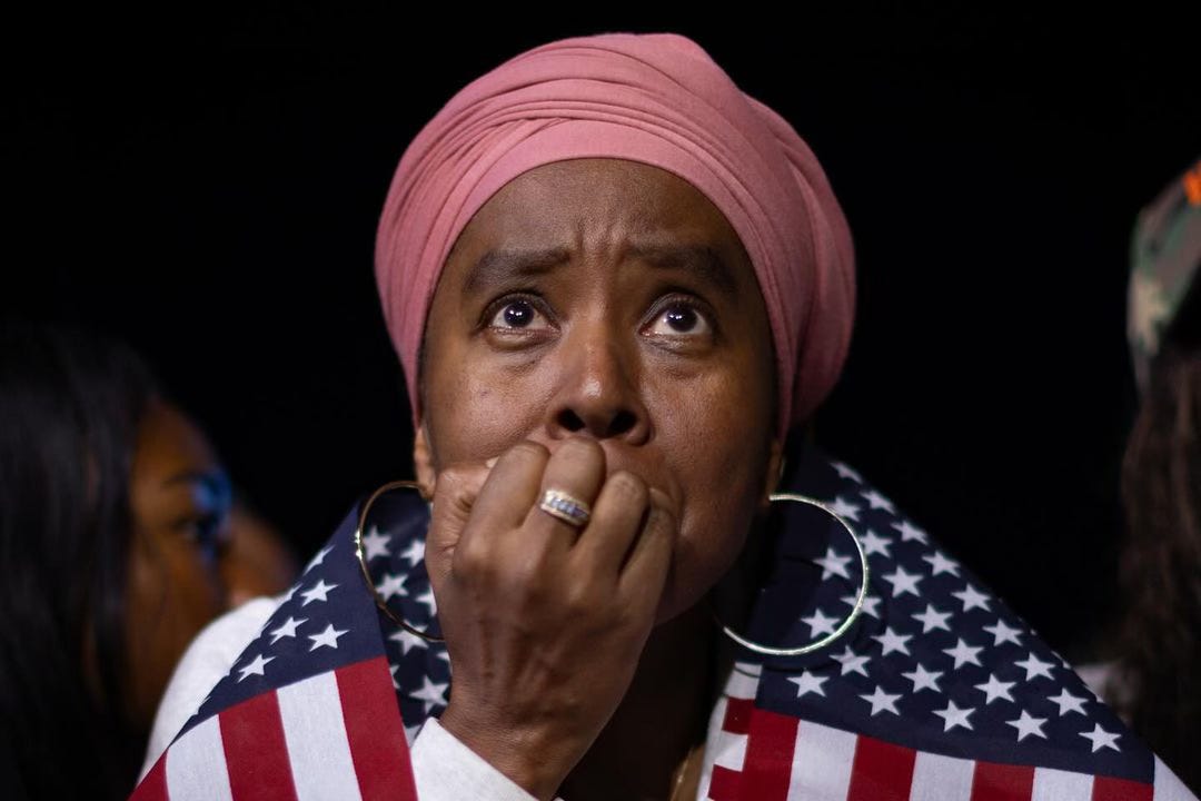 A woman at Kamala Harris's election night rally looks up with deep concern.