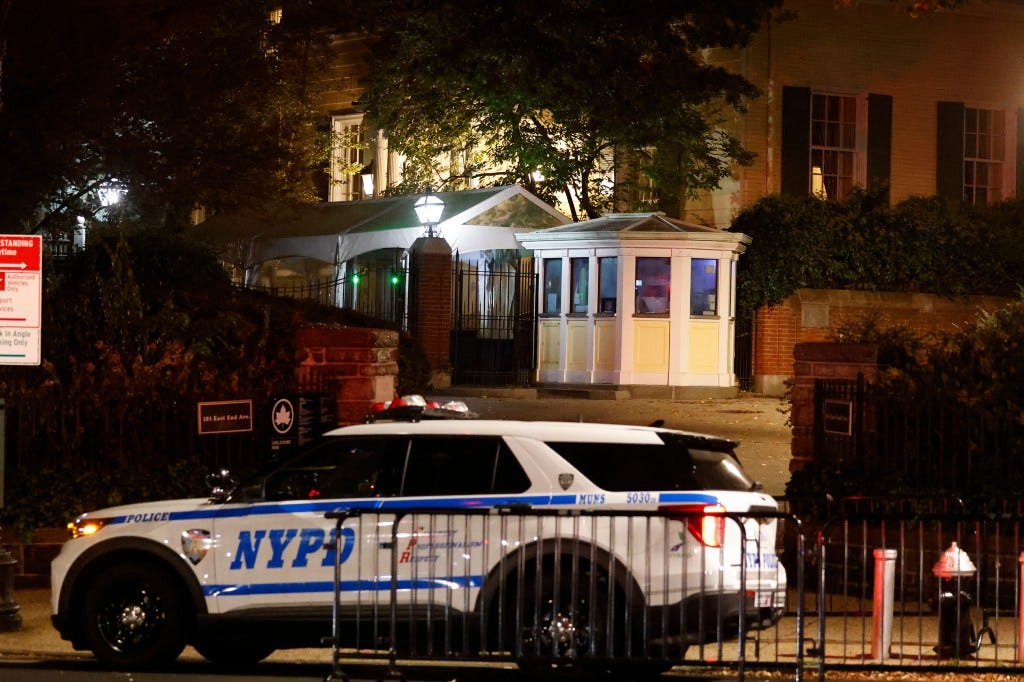 An NYPD cop car sits outside Gracie Mansion overnight, following Adams indictment.