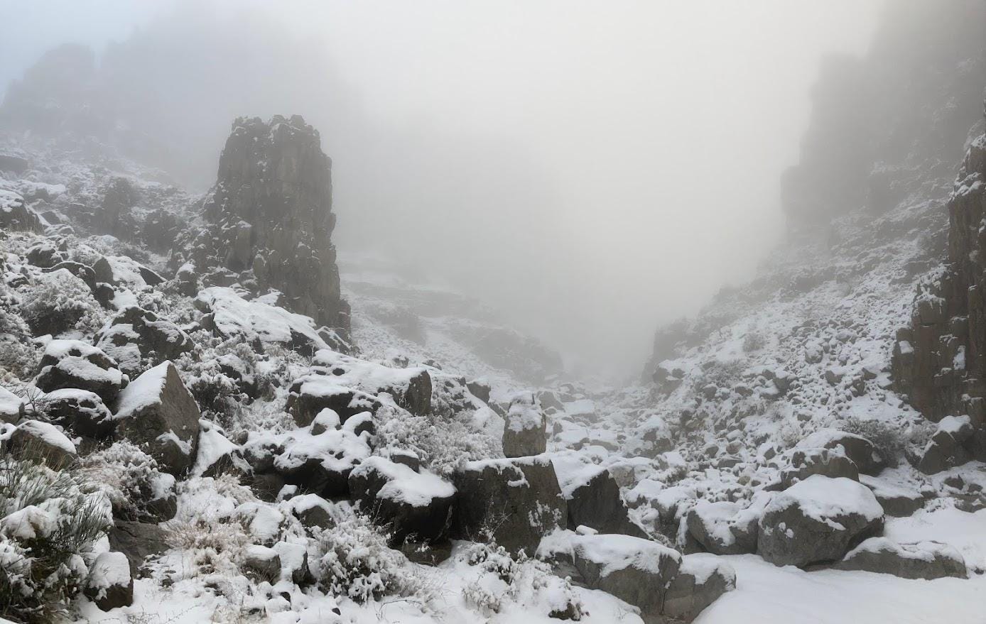 A snowy landscape with rocks and snow

Description automatically generated