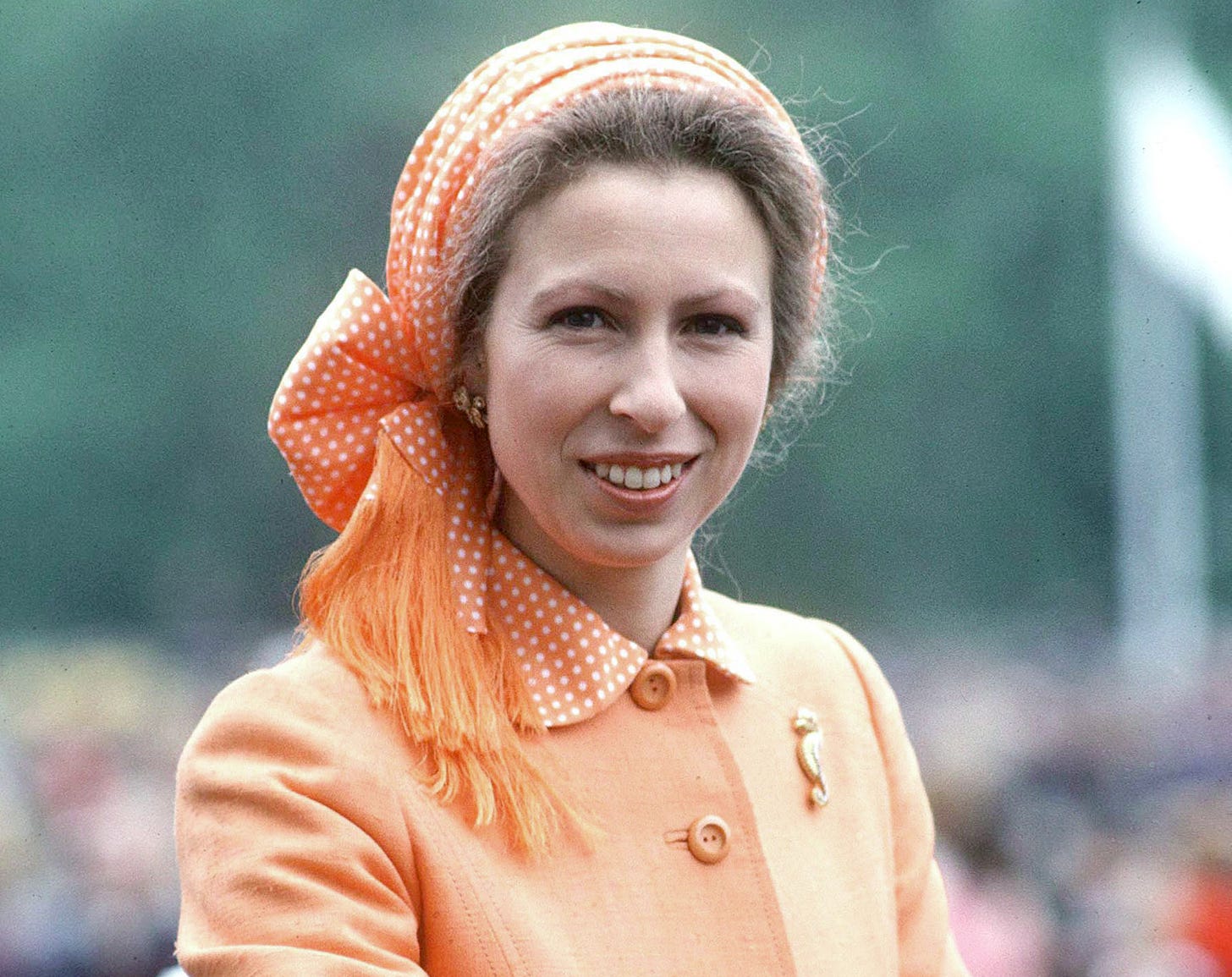 princess anne wearing orange coat and headscarf