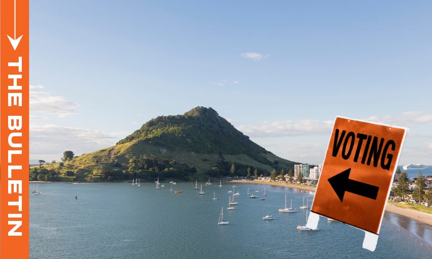 An orange voting sign over an image of Mount Maunganui on a sunny day
