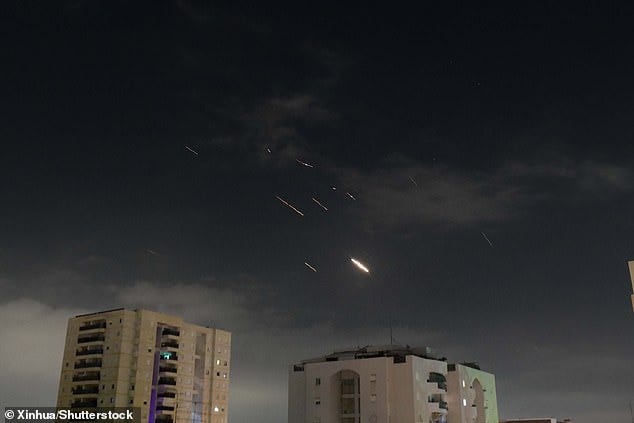 This photo taken on April 14, 2024 shows flares from explosions in the sky over Tel Aviv as Israel's anti-missile system intercepts missiles and drones from Iran