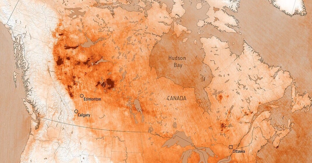 This map of Canada is heavily scored by hazy or intense red-orange lines to highlight sweeping coverage of high carbon monoxide readings across all but the far west. The colour choice gives the impression that most of Canada is scarred by fire, even though these are just gas level readings.
