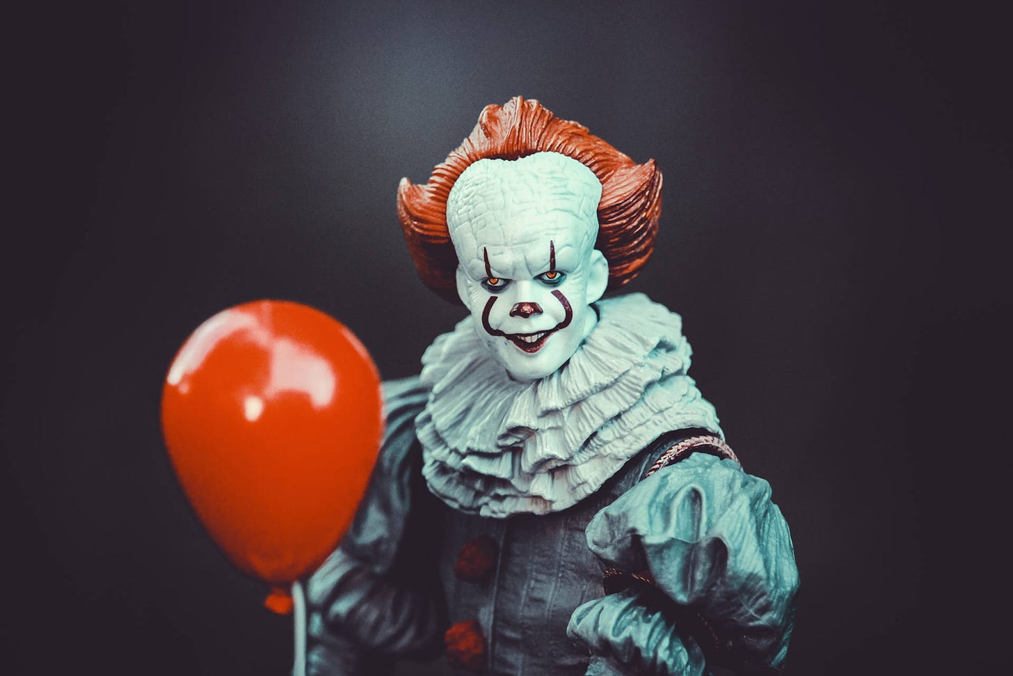 Download Spooky Pennywise Holding Red Balloon Wallpaper | Wallpapers.com