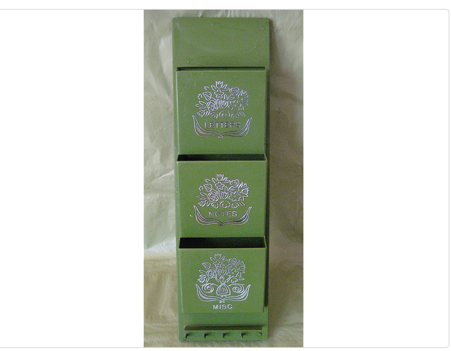 Photo of an avocado green organizer with three compartments labeled "LETTERS," "NOTES," and "MISC." The caption notes this item sold on Etsy for $12 in 2008 after failing to sell on eBay for 99 cents.
