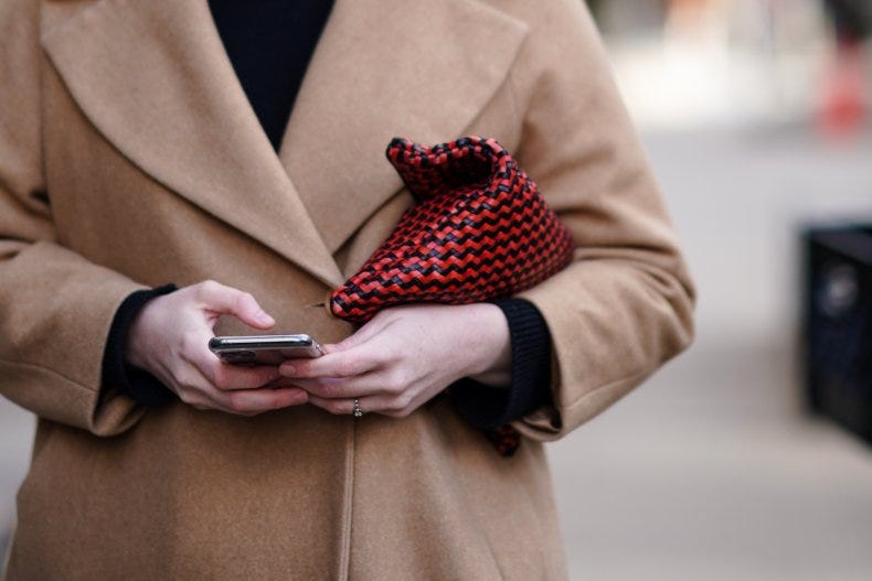 A woman holds a cellphone