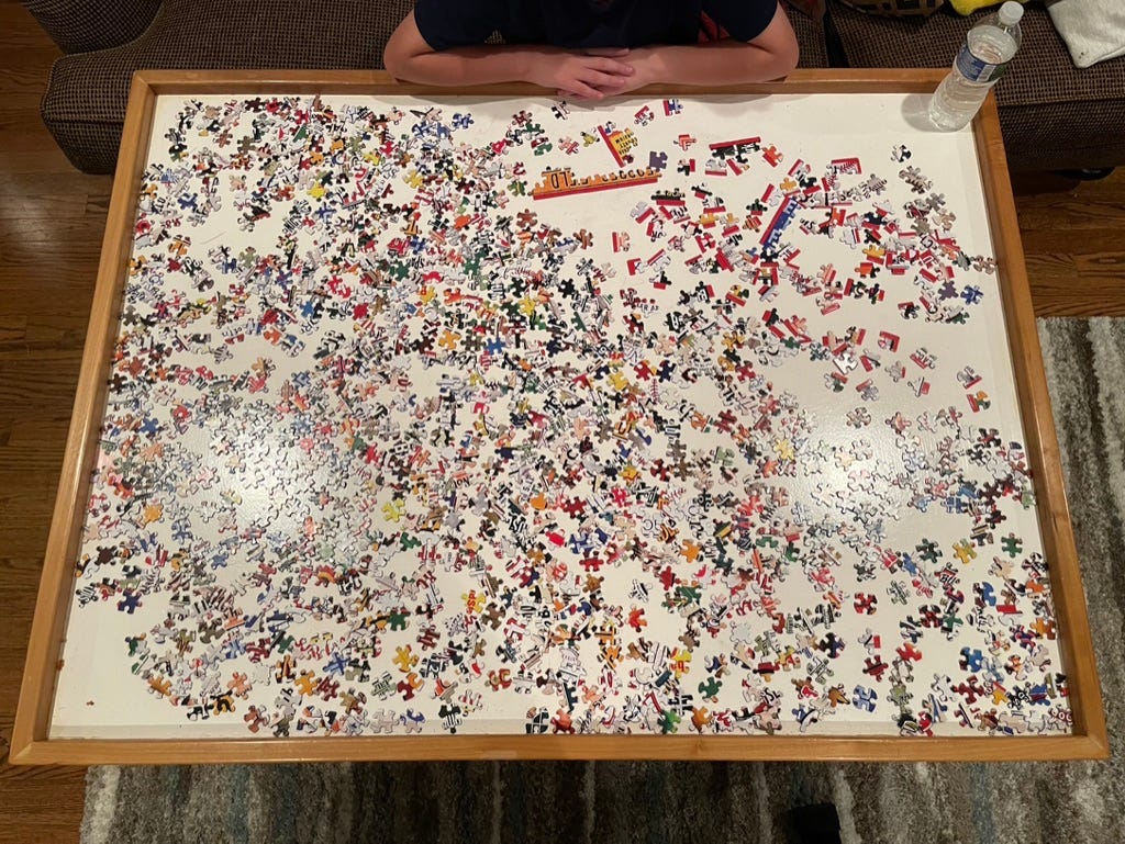 Puzzle pieces turned over, spread across the table