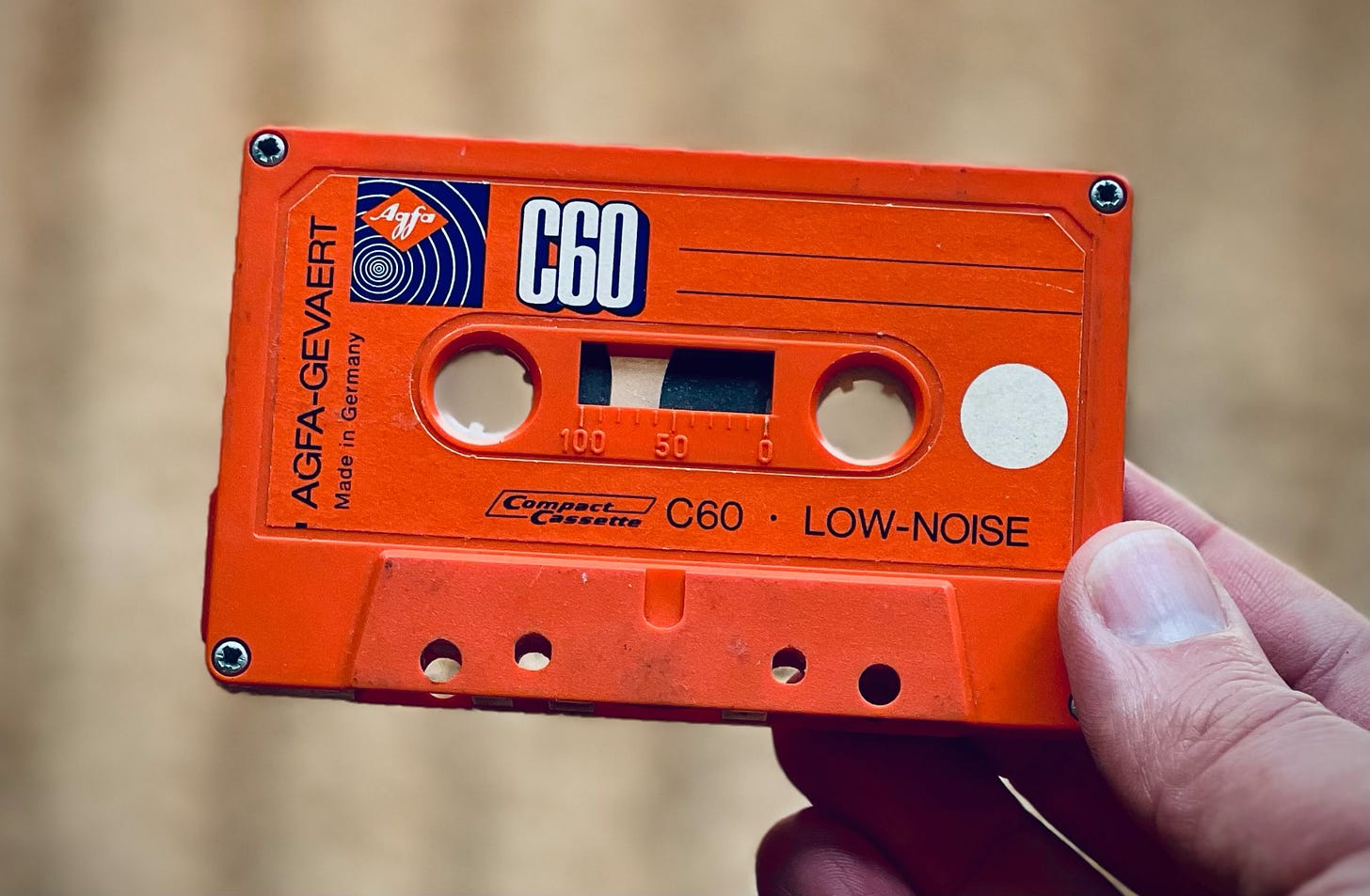 An orange cassette being held up, it's a C6 Agfa cassette.