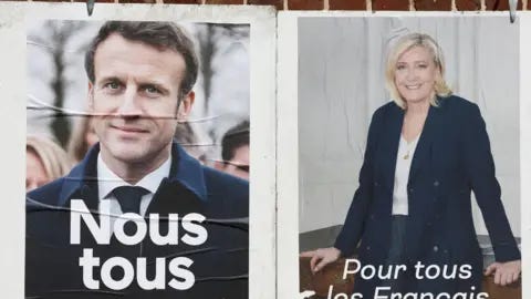 Reuters Official campaign posters of French presidential election candidates Marine le Pen, leader of French far-right National Rally (Rassemblement National) party, and French President Emmanuel Macron, 