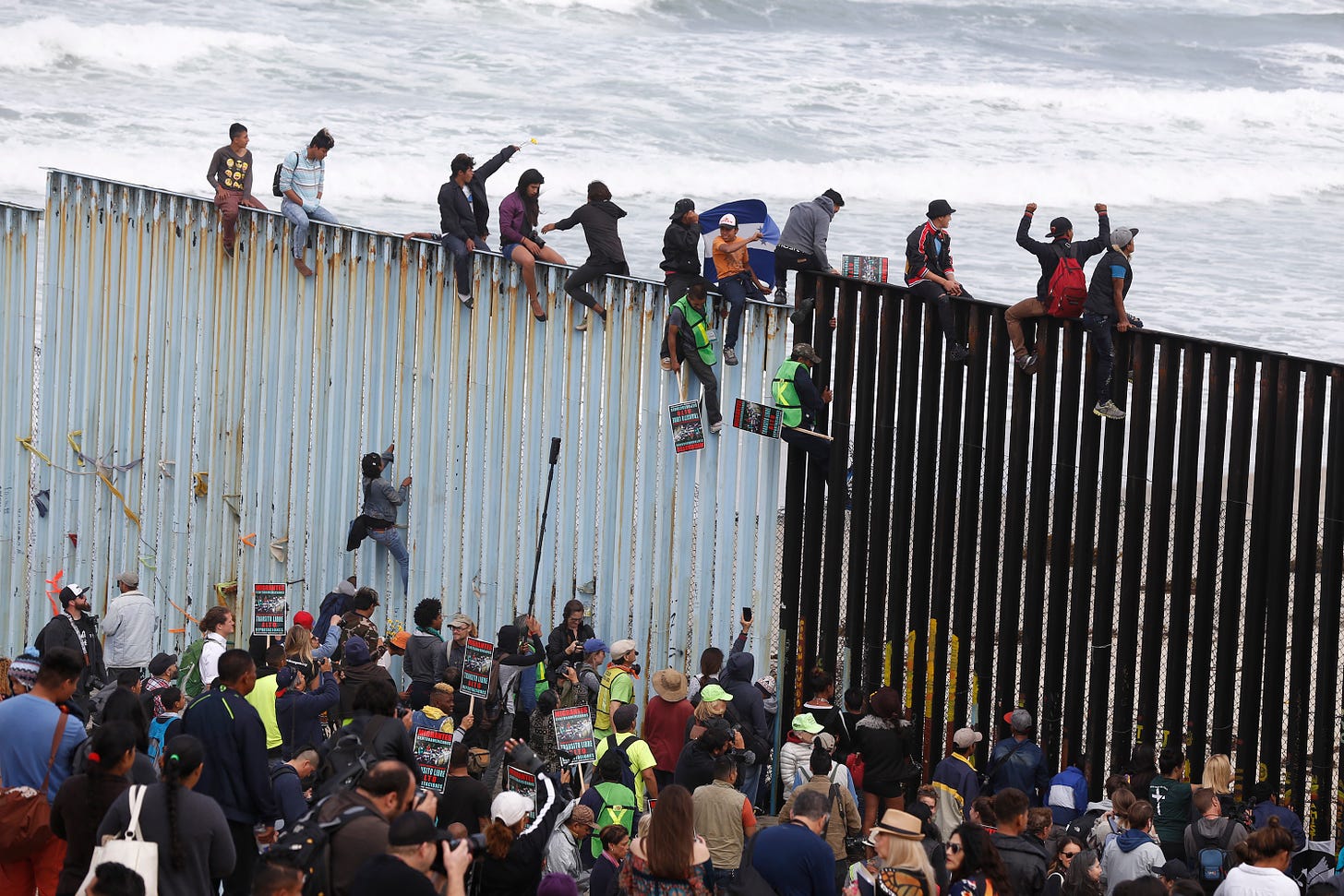 migrants scale border wall; illegal immigration