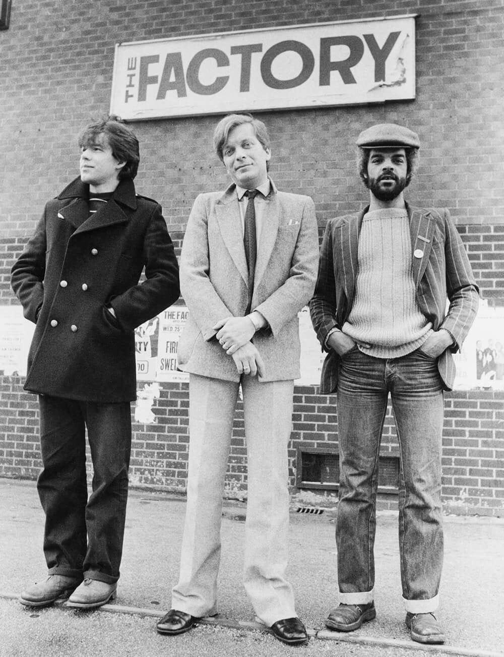 Three men standing outside Factory Records building Three men standing outside Factory Records building