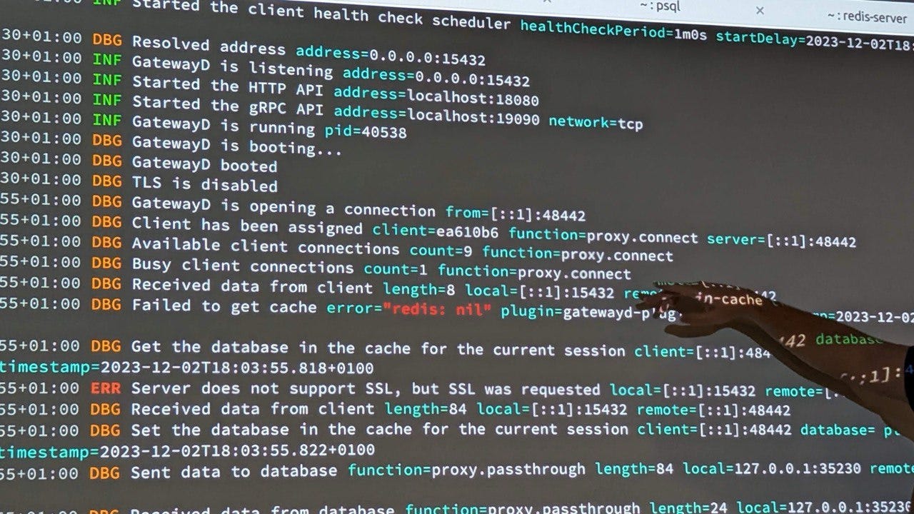 GatewayD log is displayed on the wall and Mostafa Moradian is pointing at it.