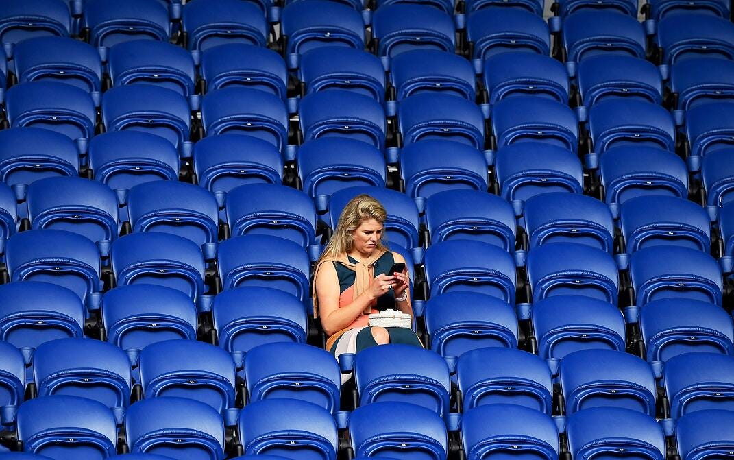 Woman sitting in a deserted stadium