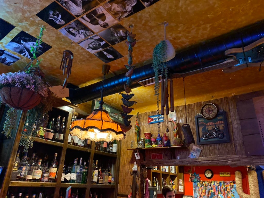 Ceiling of a bar with ohotos and lampshade