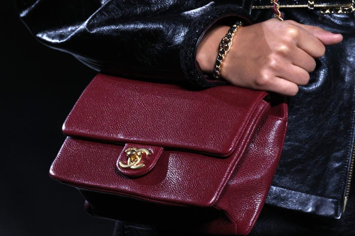 Close-up of a model's maroon Chanel handbag at Paris Fashion Week.