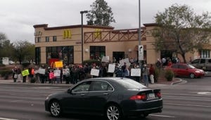 An estimated 80-100 protesters representing several liberal organizations protested low wages for fast food workers at McDonald's in midtown Tucson.