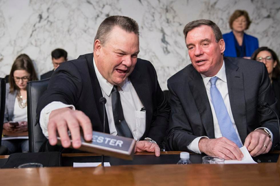 Sens. Jon Tester and Mark Warner at the Senate Banking Committee confirmation hearing for Fed chair nominee Jerome Powell, November 28, 2017